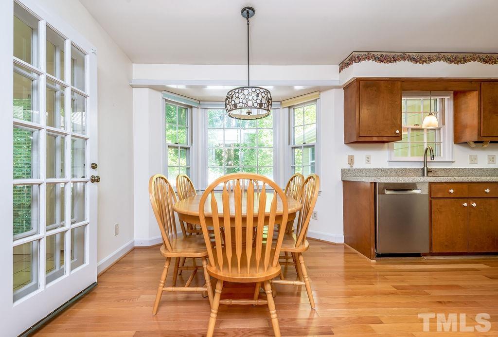215 Lawrence Road Cary, NC 27511 - Photo 15 of 28 a dining room with furniture a chandelier and wooden floor