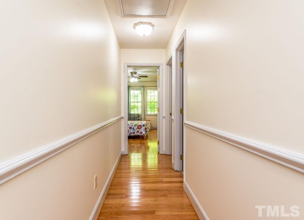 215 Lawrence Road Cary, NC 27511 - Photo 17 of 28 a view of a hallway with wooden floor and staircase