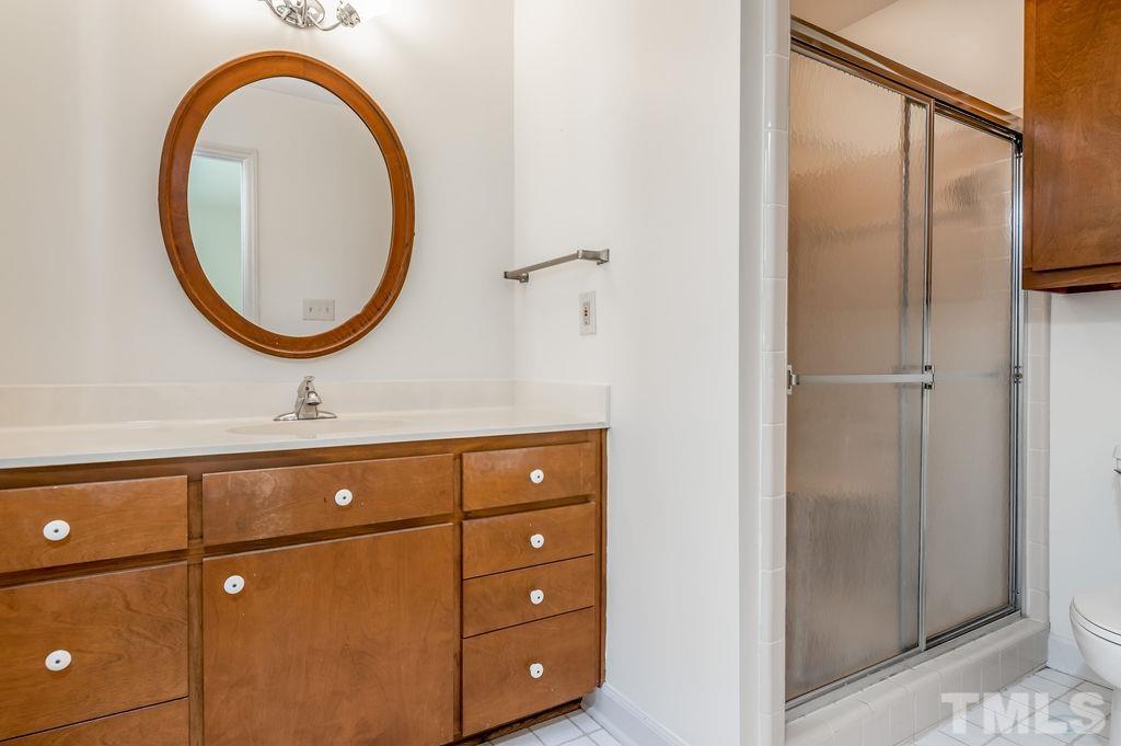 215 Lawrence Road Cary, NC 27511 - Photo 19 of 28 a bathroom with a sink and a mirror