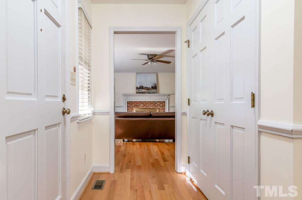 215 Lawrence Road Cary, NC 27511 - Photo 3 of 28 a kitchen with a refrigerator and a wooden floor
