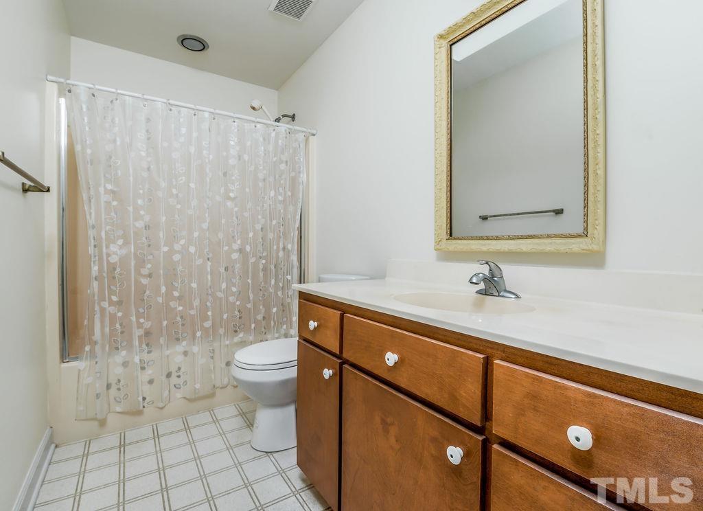 215 Lawrence Road Cary, NC 27511 - Photo 21 of 28 a bathroom with a sink a toilet and shower