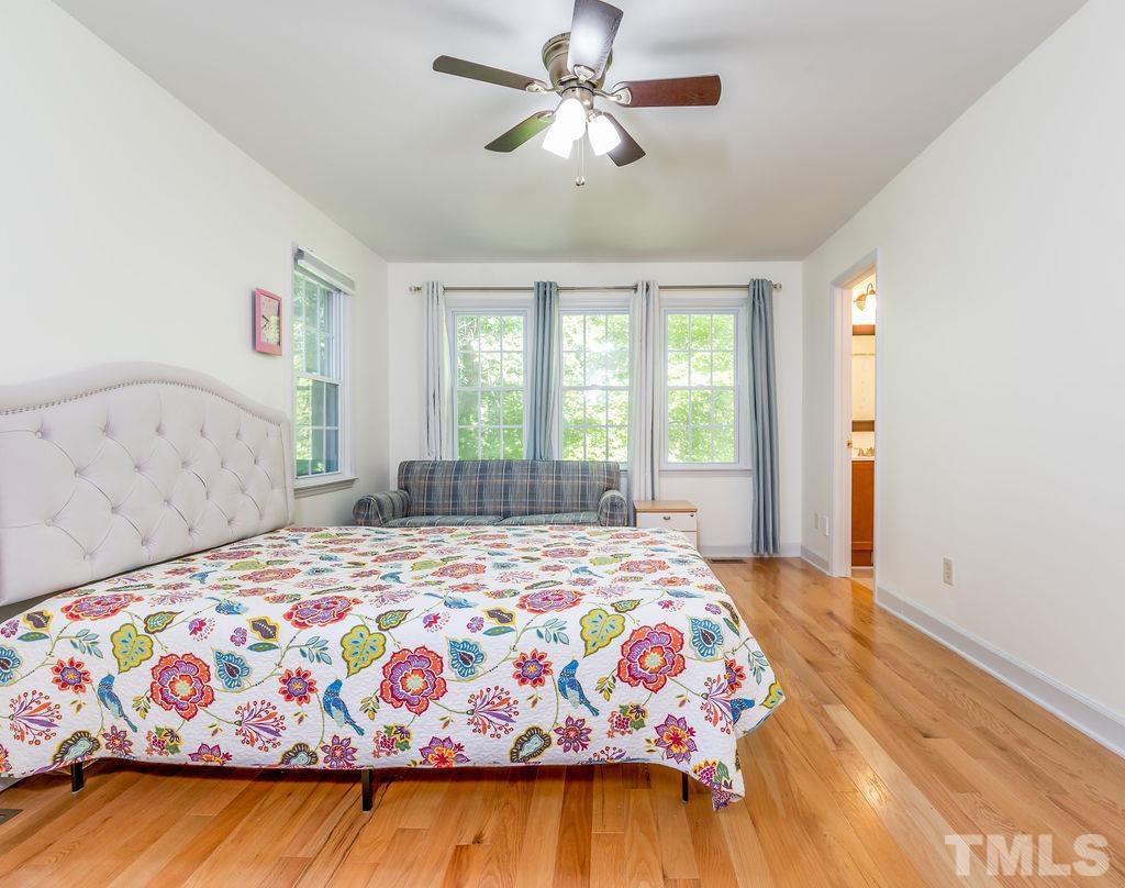 215 Lawrence Road Cary, NC 27511 - Photo 22 of 28 a bedroom with a bed and a window
