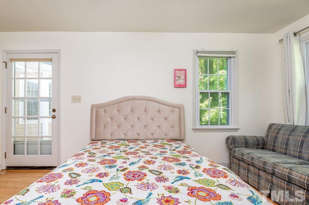 215 Lawrence Road Cary, NC 27511 - Photo 23 of 28 a bedroom with a bed and a couch
