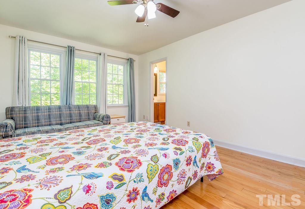 215 Lawrence Road Cary, NC 27511 - Photo 24 of 28 a bedroom with a bed and a window