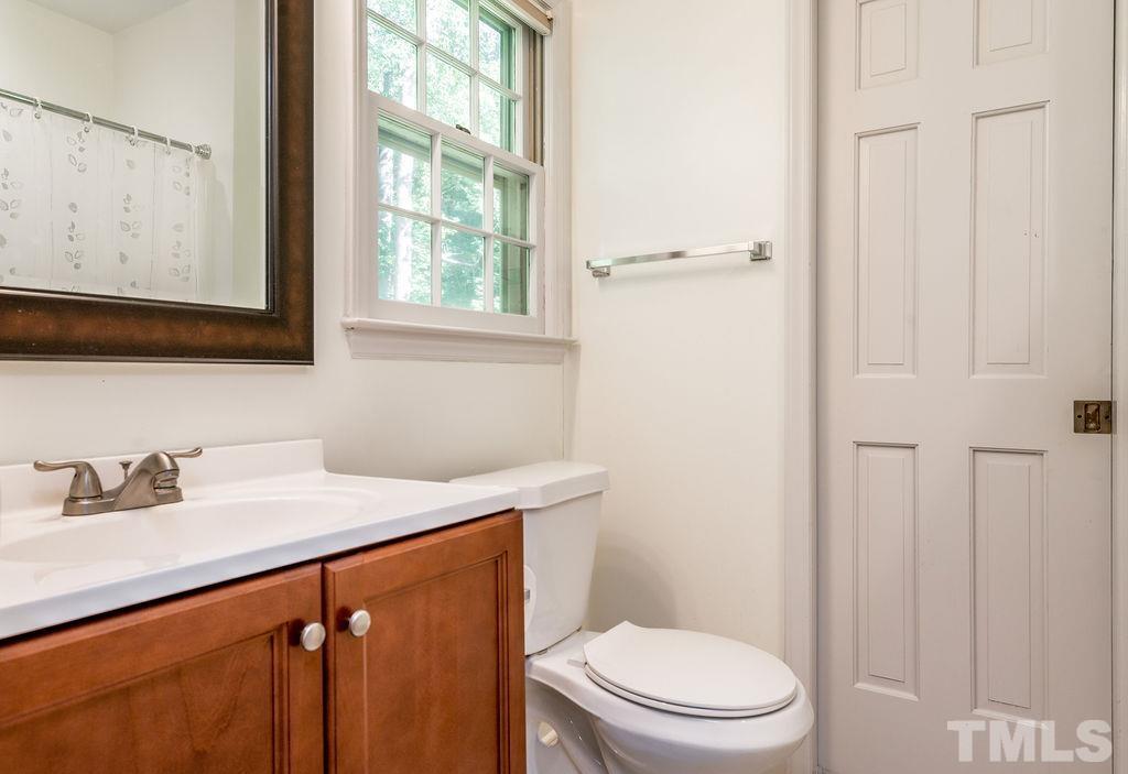 215 Lawrence Road Cary, NC 27511 - Photo 25 of 28 a bathroom with a sink a toilet and a window