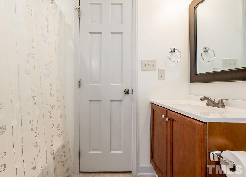 215 Lawrence Road Cary, NC 27511 - Photo 26 of 28 a bathroom with a sink and a mirror