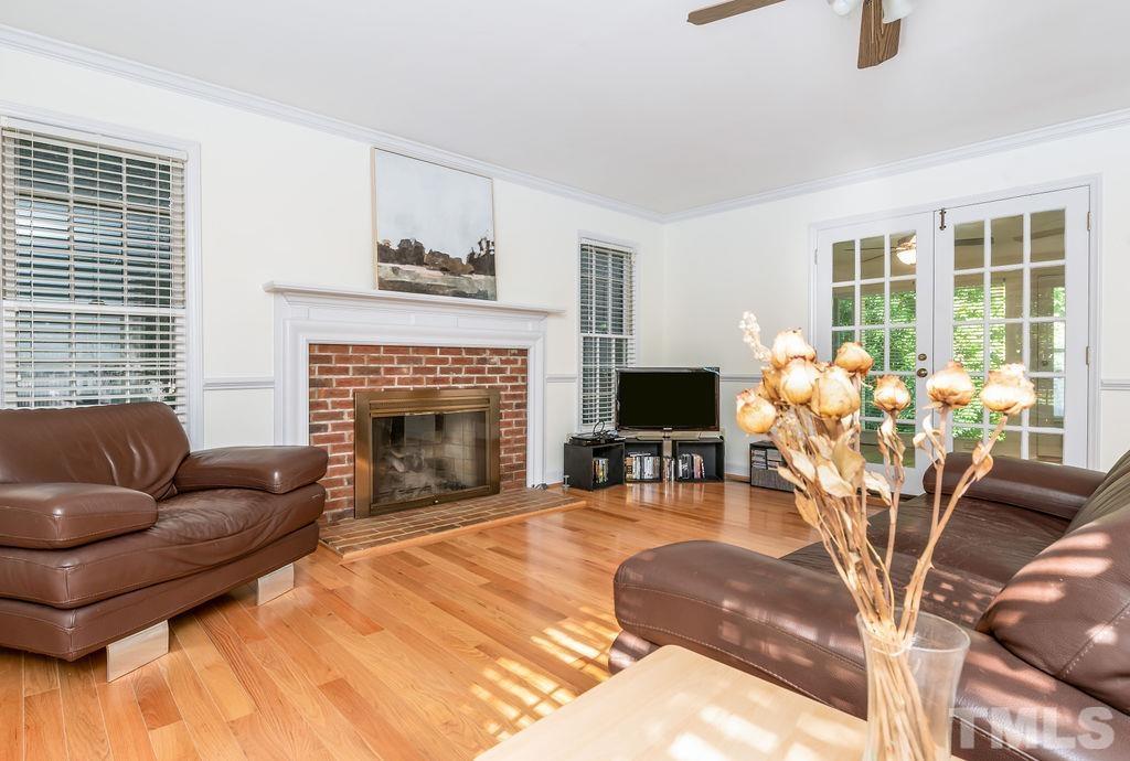 215 Lawrence Road Cary, NC 27511 - Photo 6 of 28 a living room with furniture fireplace and potted plants