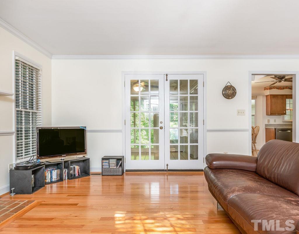 215 Lawrence Road Cary, NC 27511 - Photo 7 of 28 a living room with furniture and a flat screen tv