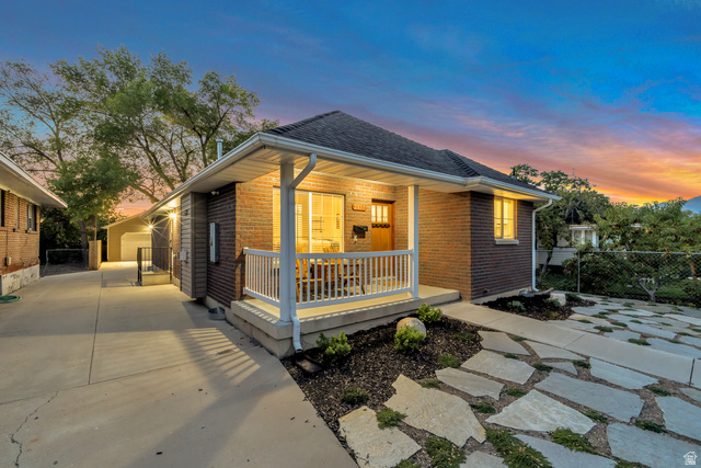 Undisclosed Address Ogden, UT 84403 - Photo 1 of 21 View of front facade featuring a porch, a shingled roof, and brick siding