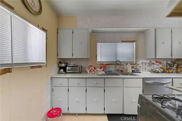 a kitchen that has a sink and a stove