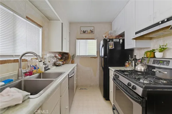 a kitchen that has a sink and a stove
