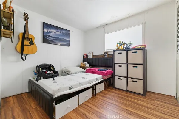 a view of a bedroom with closet and mirror