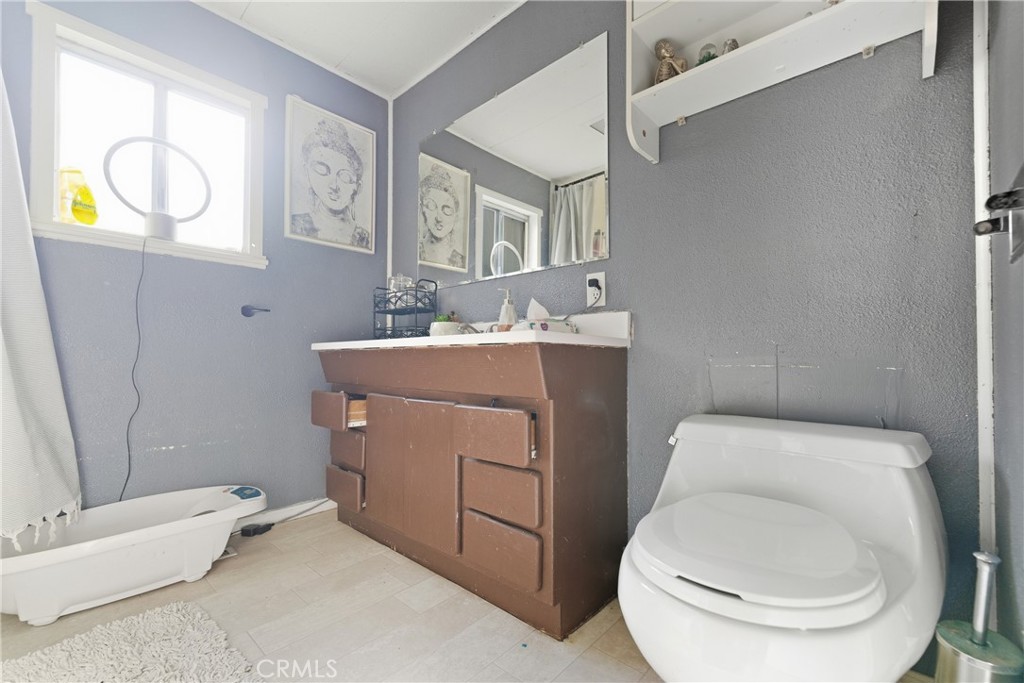 36200 Paradise Ranch Road Castaic, CA 91384 - Photo 25 of 31 a bathroom with a toilet sink and mirror
