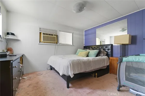 a bedroom with a bed and walk in closet