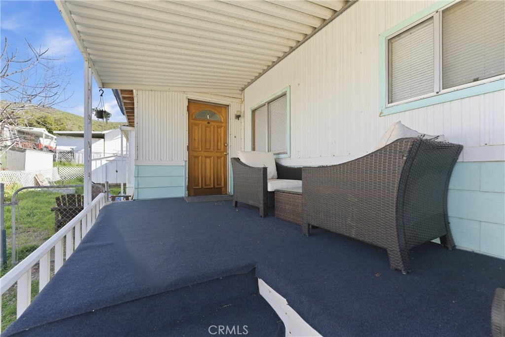 36200 Paradise Ranch Road Castaic, CA 91384 - Photo 7 of 31 a balcony of a house with wooden floor and outdoor space