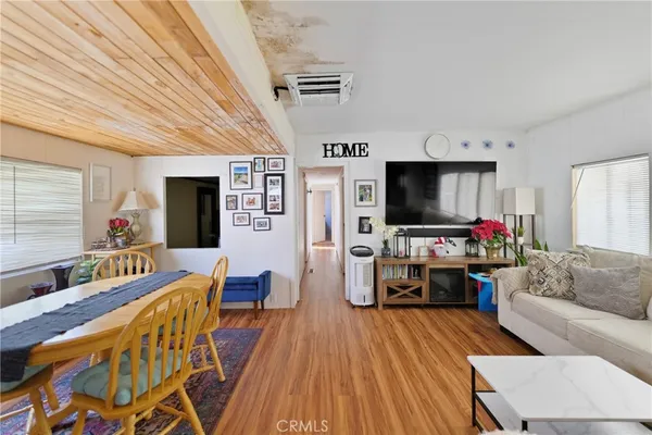 a view of a dining room with furniture wooden floor and front door