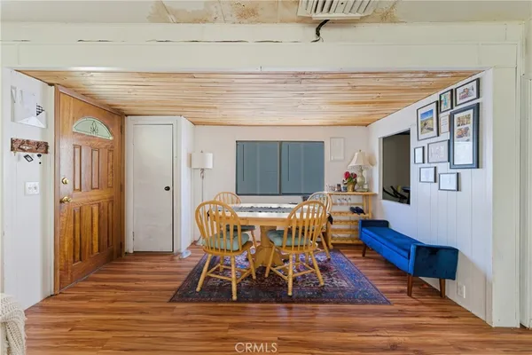 a living room with furniture a rug potted plant and a large window