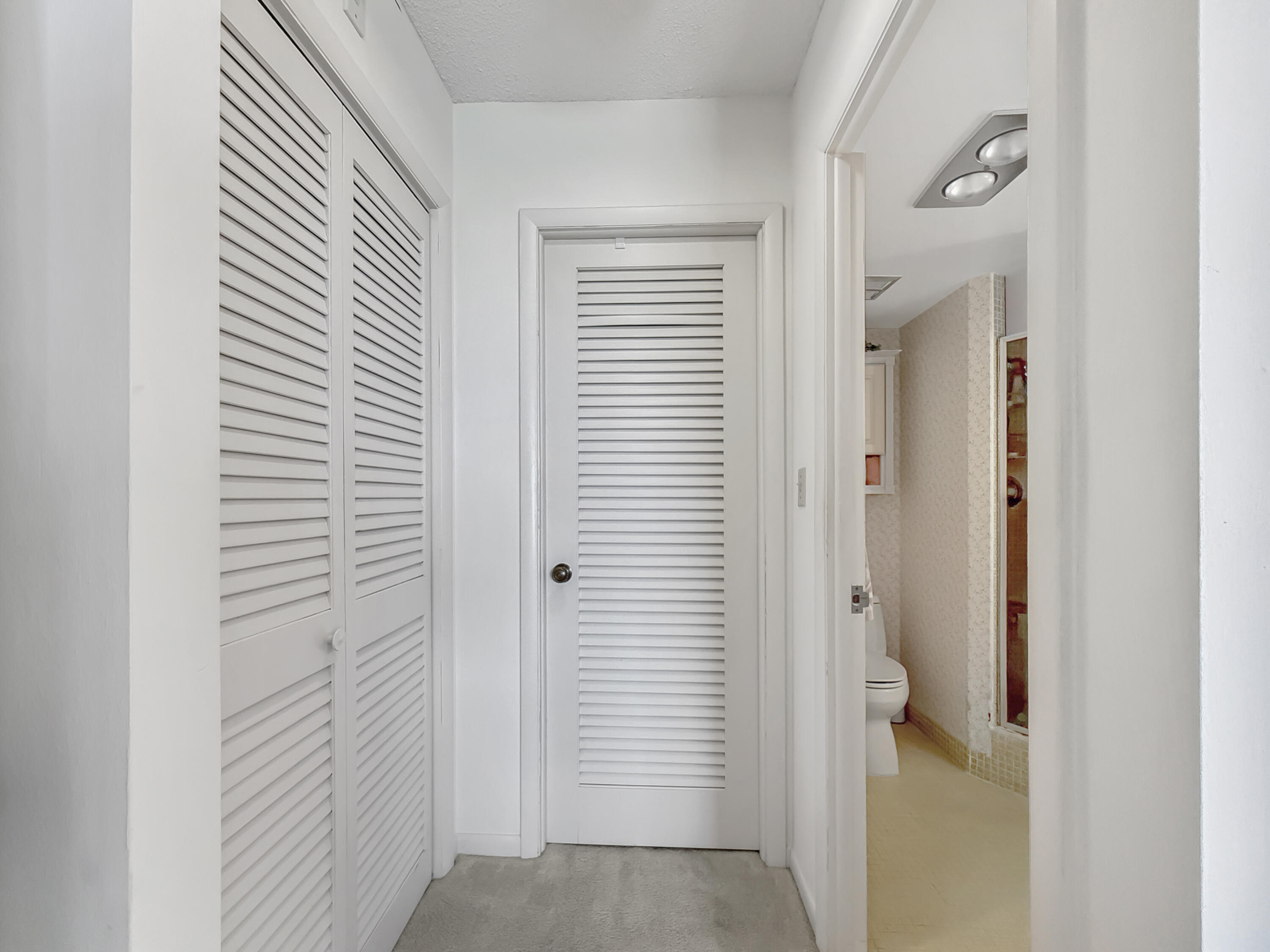 555 Northwest 4th Avenue, Unit 401 Boca Raton, FL 33432 - Photo 27 of 41 Primary Bedroom Closet Hallway