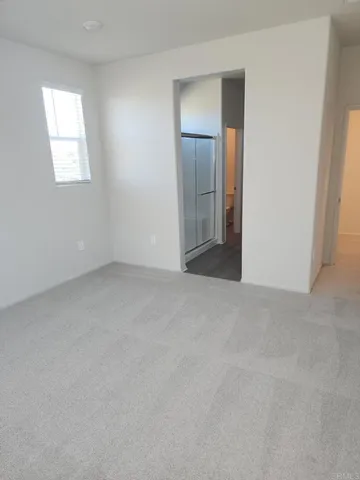 an empty room with windows and closet