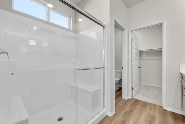 a bathroom with a glass shower door