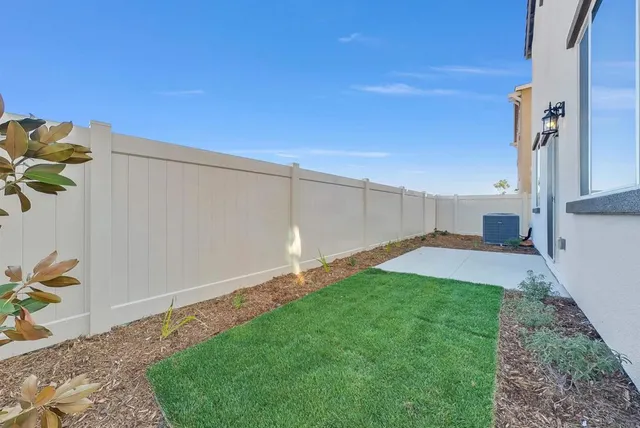 a view of a house with backyard sitting area and garden
