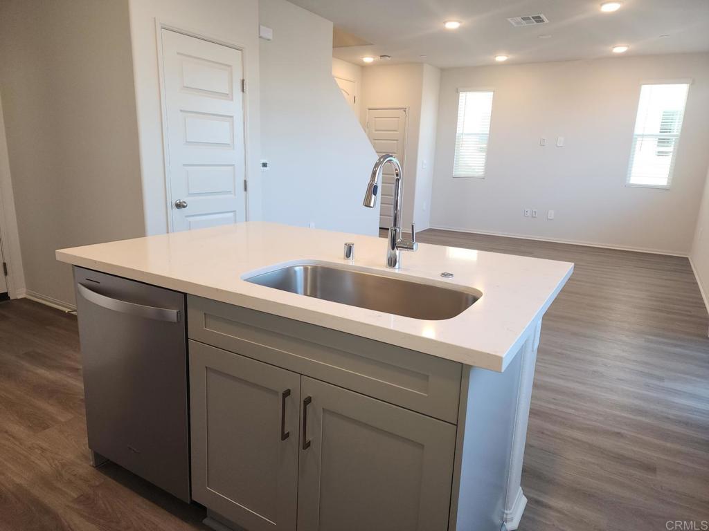 28386 Via Solero Temecula, CA 92591 - Photo 4 of 17 a kitchen with a sink a wooden floor and white cabinet