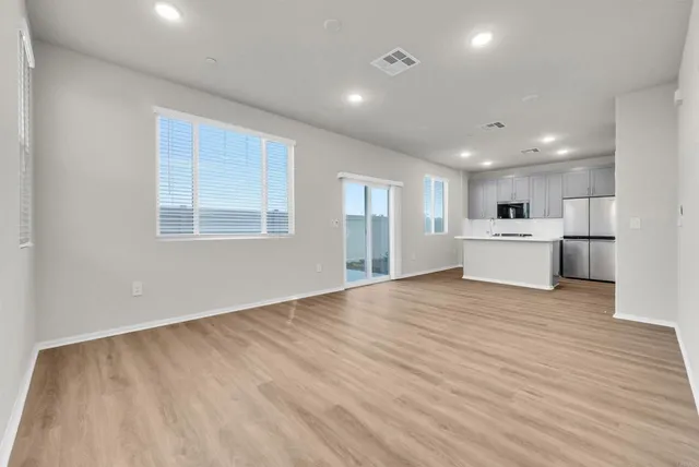 a view of a kitchen with a sink and a refrigerator