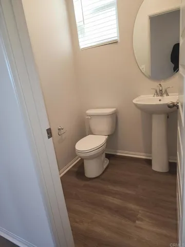 a bathroom with a toilet sink and a mirror
