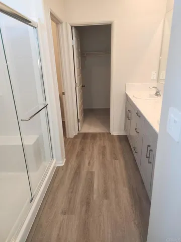 a bathroom with a sink a mirror a bathtub and shower