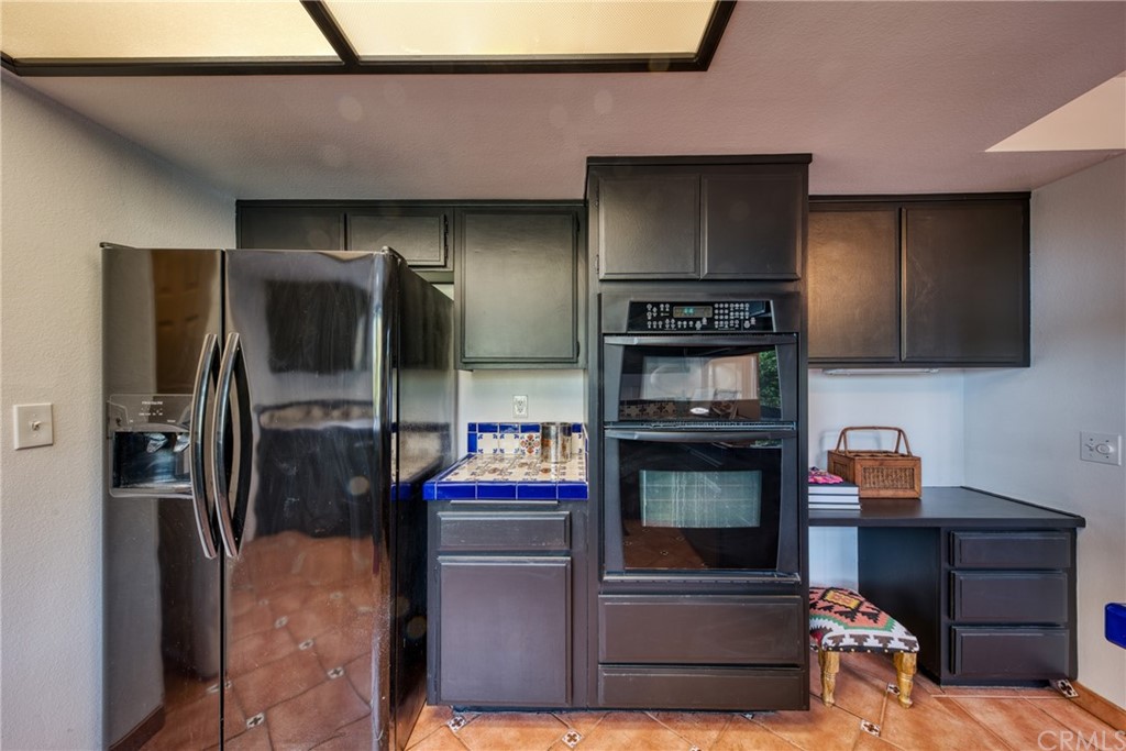 314 Shadow Lane Monrovia, CA 91016 - Photo 12 of 43 a kitchen with stainless steel appliances kitchen island granite countertop a refrigerator and a stove