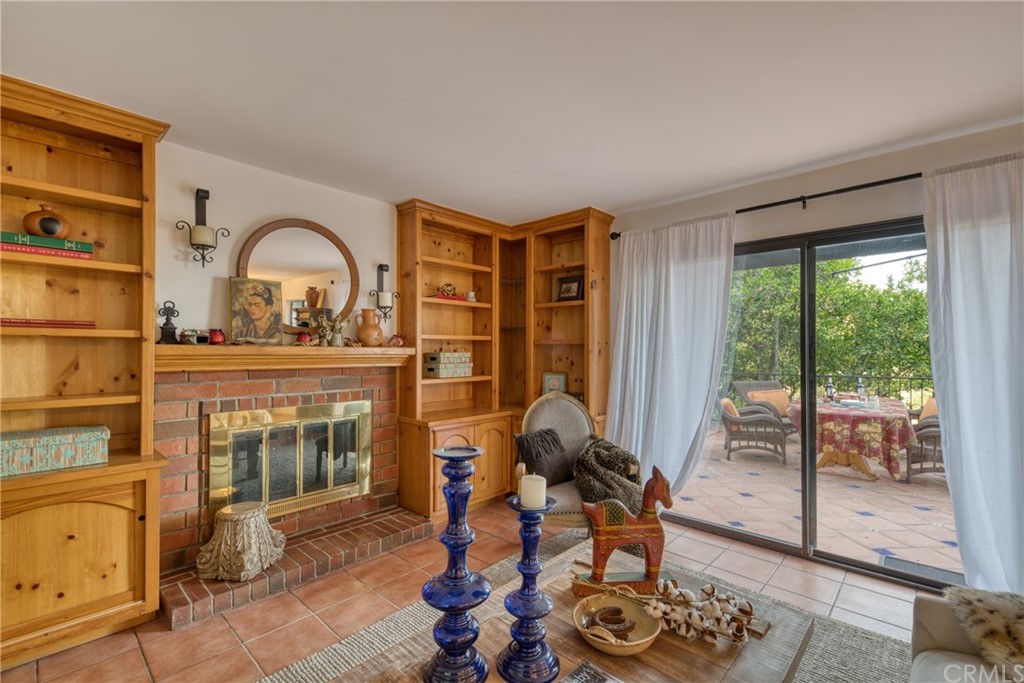 314 Shadow Lane Monrovia, CA 91016 - Photo 16 of 43 a living room with furniture a fireplace and a floor to ceiling window