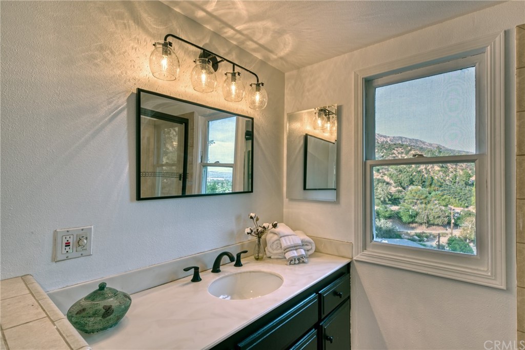 314 Shadow Lane Monrovia, CA 91016 - Photo 23 of 43 a bathroom with a sink a mirror and a window