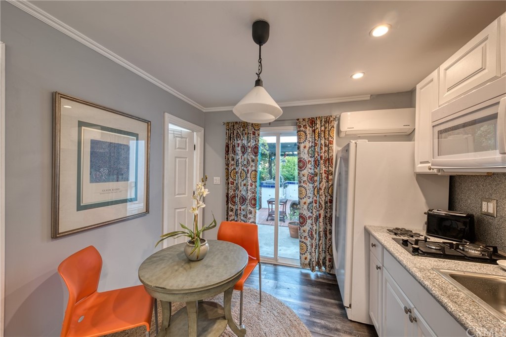 314 Shadow Lane Monrovia, CA 91016 - Photo 34 of 43 a kitchen with stainless steel appliances granite countertop a dining table chairs stove and white cabinets
