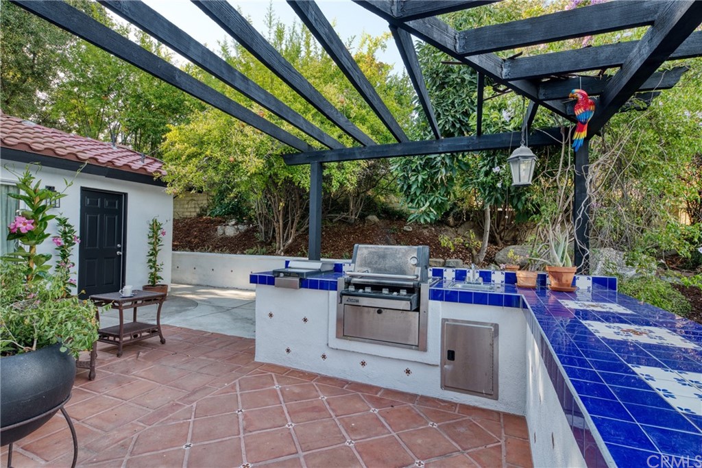 314 Shadow Lane Monrovia, CA 91016 - Photo 38 of 43 a view of a patio with table and chairs potted plants with wooden floor and fence