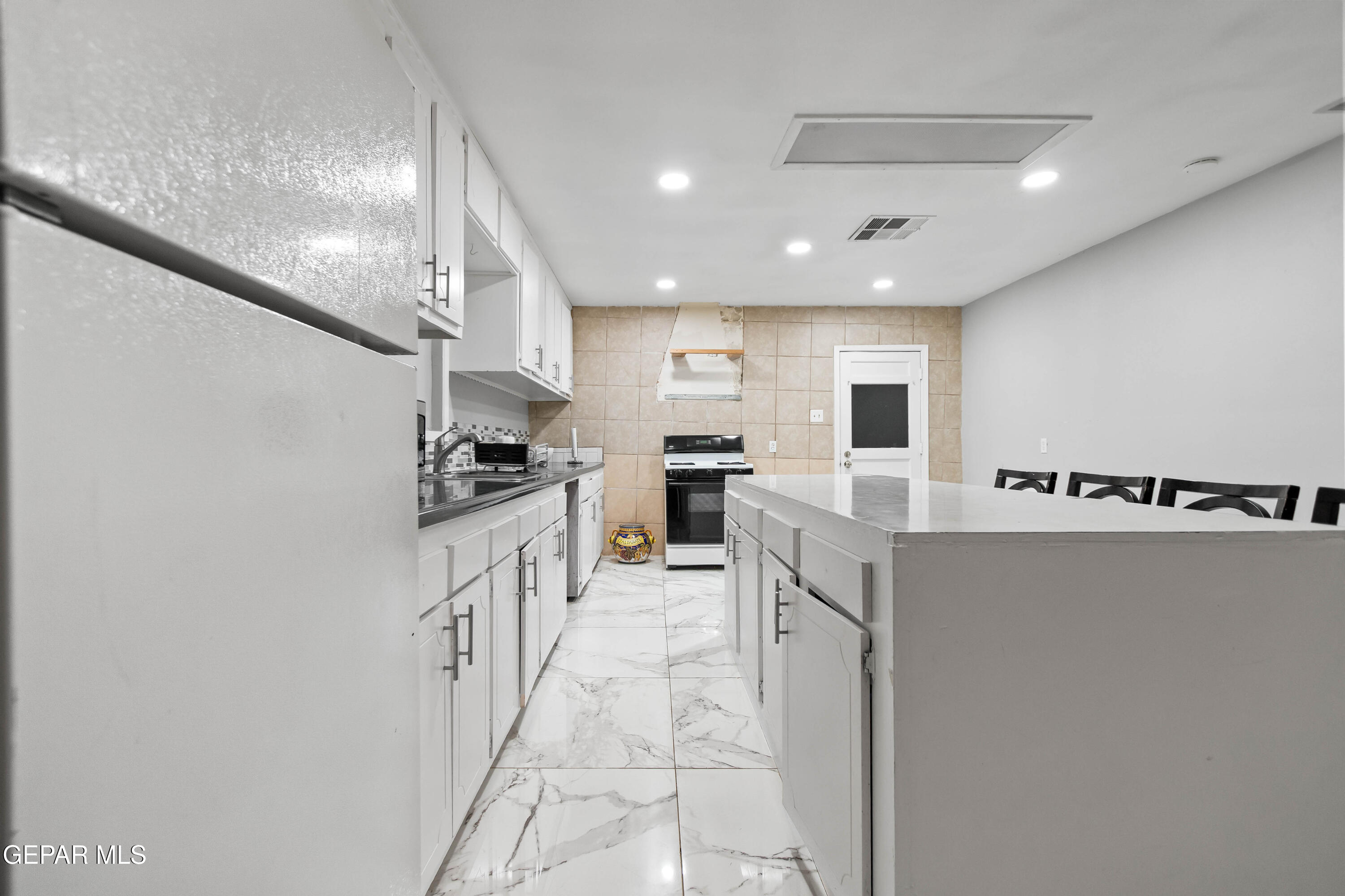 171 Holguin Avenue Vinton, TX 79821 - Photo 13 of 35 a kitchen with granite countertop a sink and counter top space