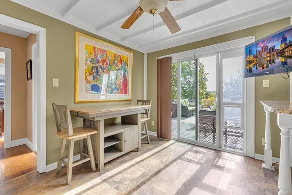a view of a livingroom with furniture and a ceiling fan