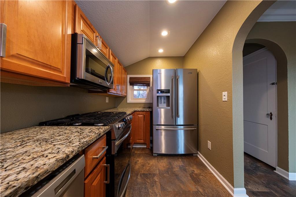 979 Seventh Street Beaver, PA 15009 - Photo 18 of 44 a kitchen with granite countertop stainless steel appliances and wooden cabinets