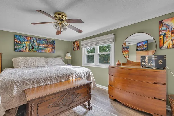 a bedroom with a bed and a large window