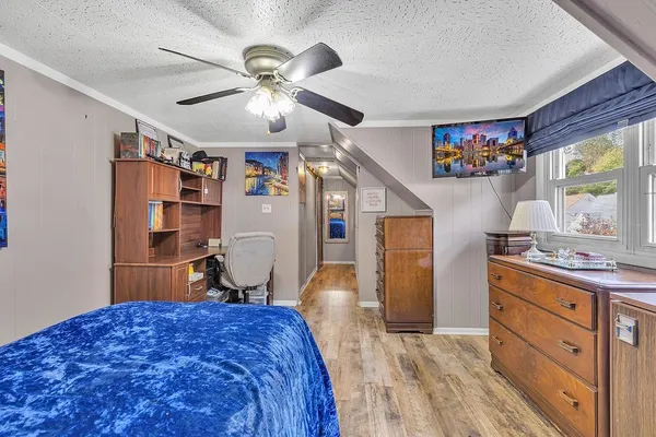 a bedroom with a bed and a chandelier