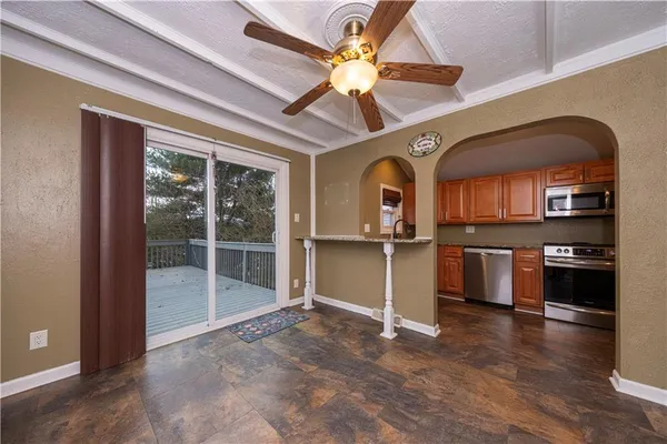 a view of a livingroom with a fireplace and wooden floor