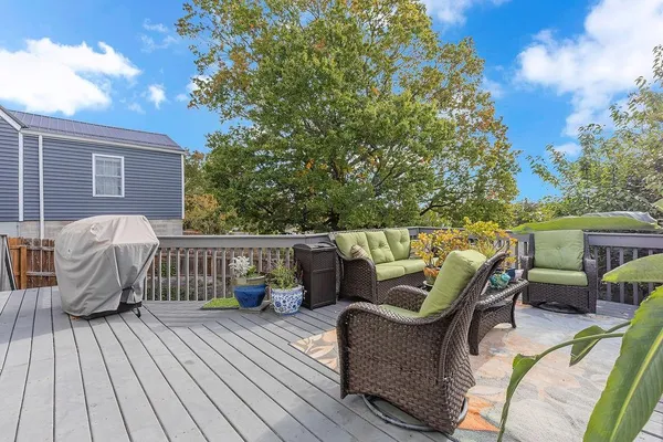 a view of a roof deck with furniture