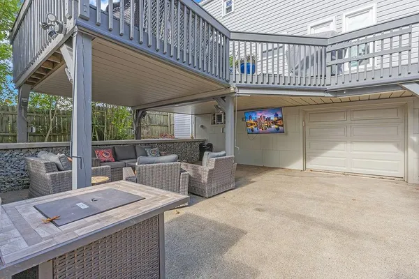 a view of a chairs and table in the roof deck