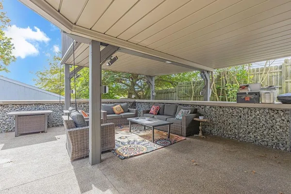 a view of a patio with table and chairs potted plants with wooden fence