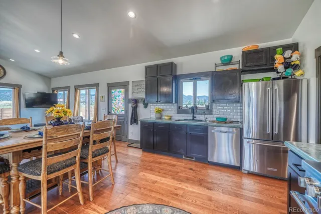 a kitchen with stainless steel appliances kitchen island granite countertop a refrigerator and microwave