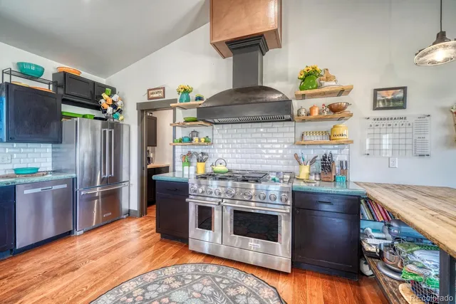a kitchen with stainless steel appliances granite countertop a stove a sink dishwasher and refrigerator