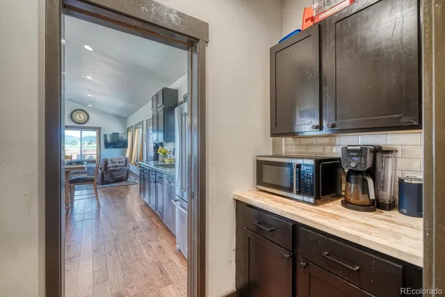 a hallway with sink and cabinets