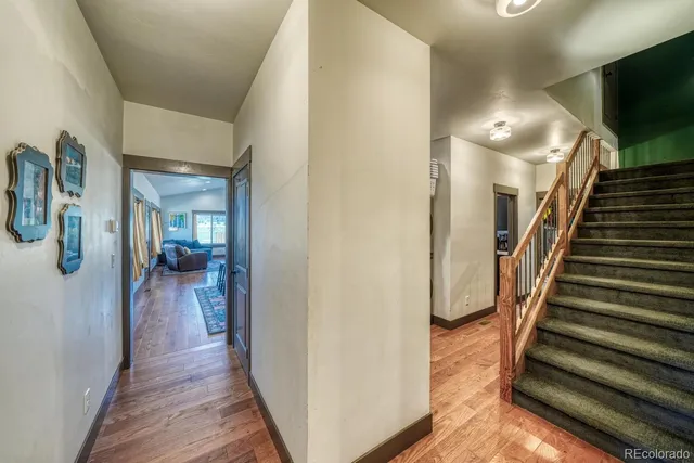 a view of a hallway view with wooden floor and staircase