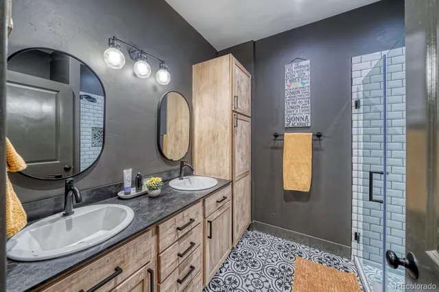 a bathroom with a double vanity sink and a mirror