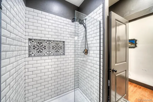 a bathroom with a shower and a glass door