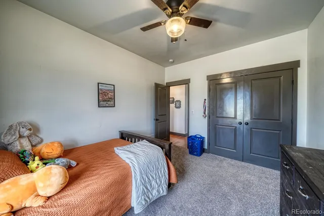 a bedroom with a bed and ceiling fan